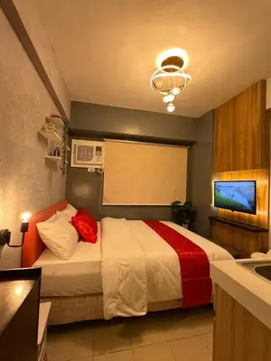 a hotel room with a bed and a sink at PaulBert's Cabins III in Manila