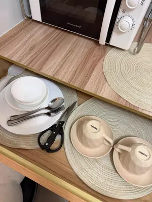 a table with plates and utensils on a counter at PaulBert's Cabins III in Manila