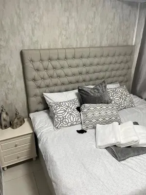 a bedroom with a bed with pillows on it at Spacious 2BR in Shore3 in Manila