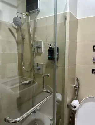a bathroom with a glass shower with a toilet at Spacious 2BR in Shore3 in Manila