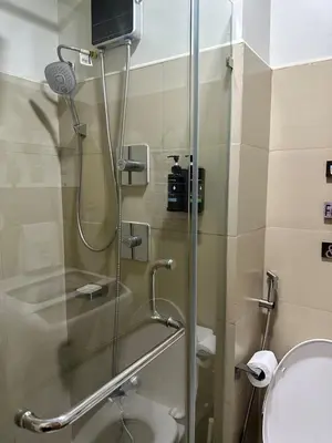 a shower with a glass door in a bathroom at Spacious 2BR in Shore3 in Manila