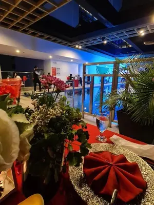 a table with flowers on top of a table at The Residences BCCT in Manila