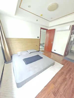 a bedroom with a large bed in a room at Star Steward Guest Services in Manila