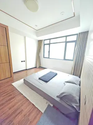 a bedroom with a large bed and a window at Star Steward Guest Services in Manila