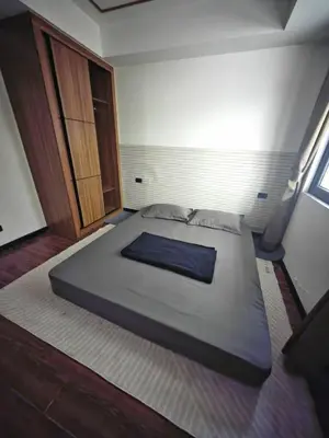 a bedroom with a large bed in a room at Star Steward Guest Services in Manila