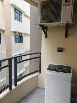 a balcony with a air conditioner and a washing machine at Star Steward Guest Services in Manila