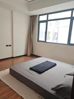 a large bed in a room with a large window at Star Steward Guest Services in Manila
