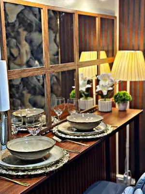 a table with plates and wine glasses on it at Shore 2 Residence Erlinda suite in Manila