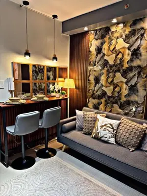 a living room with a couch and a bar at Shore 2 Residence Erlinda suite in Manila