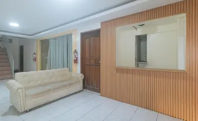 a living room with a couch and a mirror at RedDoorz at FCCG GoldMoon Boutique Hotel in Manila