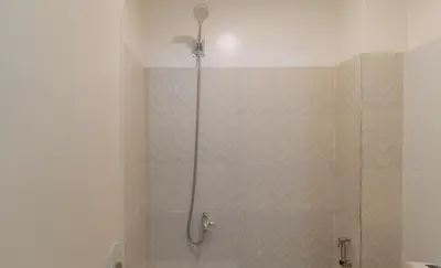 a shower with a glass door in a bathroom at RedDoorz at FCCG GoldMoon Boutique Hotel in Manila
