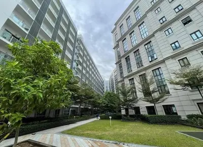 two tall buildings with trees in front of them at Eighty One Newport Blvd Condo near NAIA3 in Manila