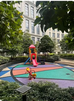 a playground in a park in front of a building at Eighty One Newport Blvd Condo near NAIA3 in Manila