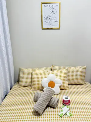 a couch with a teddy bear and other toys on it at Cozy Condo at SMDC Charm Cainta in Manila