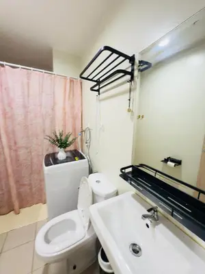 a bathroom with a toilet and a sink at Cozy Condo at SMDC Charm Cainta in Manila
