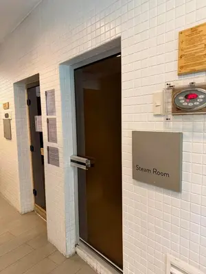 a door to a steam room with a sign on a wall at Deluxe Room with Pool View Unit in Poblacion in Manila