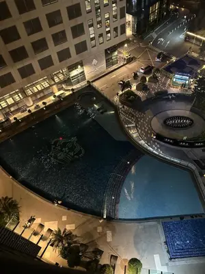 an overhead view of a large swimming pool in a building at Deluxe Room with Pool View Unit in Poblacion in Manila