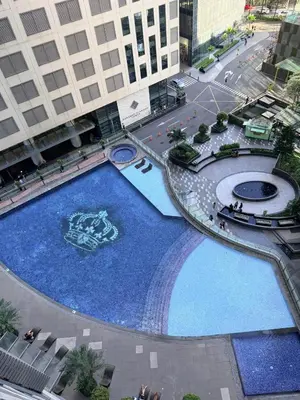 an overhead view of a large swimming pool in a city at Deluxe Room with Pool View Unit in Poblacion in Manila
