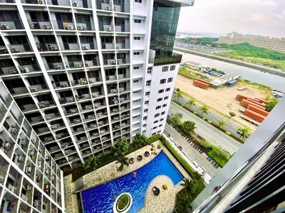 an aerial view of a building with a swimming pool at Ameera Condo Stay in Manila