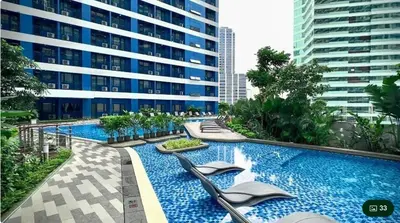 a swimming pool in the middle of a building at Budget-Friendly Condo in Makati in Manila