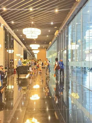 a group of people walking through a building at Budget-Friendly Condo in Makati in Manila