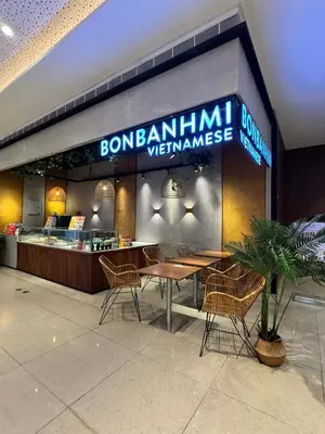 a restaurant with a table and chairs in a building at Budget-Friendly Condo in Makati in Manila