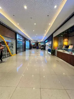 an empty shopping mall with lights on the floor at Budget-Friendly Condo in Makati in Manila