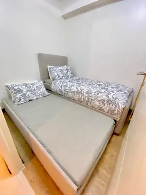 a small bed in a room with a mattress at Brand New Cozy 2 BR unit in Pasig in Manila