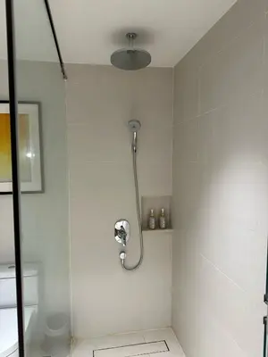 a shower in a bathroom with a glass door at Premium Twin Suite at Novotel Acqua - City View in Manila
