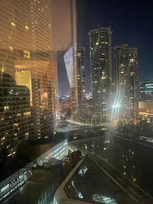 a view of a city skyline at night at Premium Twin Suite at Novotel Acqua - City View in Manila