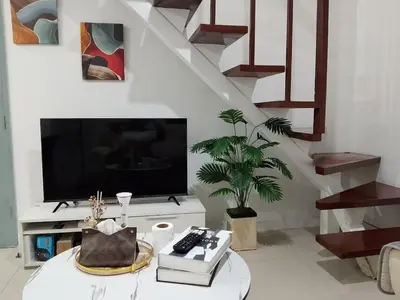 a living room with a tv and a table at Luxury 2BR with Stunning Skyline Views in BGC in Manila