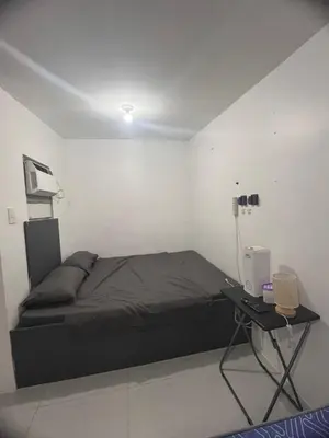 a bedroom with a bed and a desk with a computer at Alilonch Transient