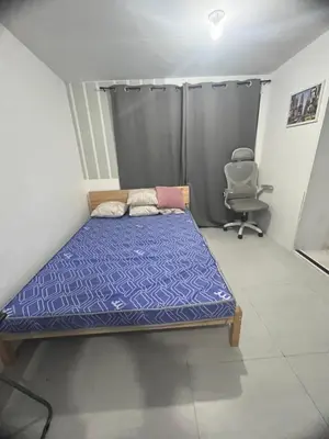 a small bedroom with a bed and a chair at Alilonch Transient
