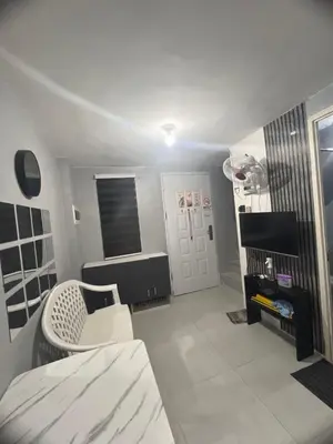 a room with a bed and a chair in it at Alilonch Transient