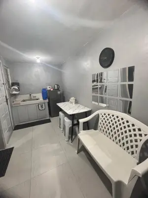 a living room with a table and a kitchen at Alilonch Transient