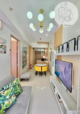 a living room with a large flat screen tv at The Turianos in Manila