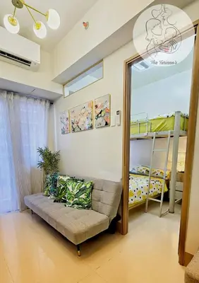 a living room with a couch and bunk beds at The Turianos in Manila