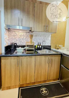 a kitchen with wooden cabinets and a sink at The Turianos in Manila