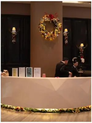 two men standing at a counter in a room at STAYLUXIA BOUTIQUE HOTEL KNIGHTSBRIDGE Pool Netflix Free Amenities in Manila