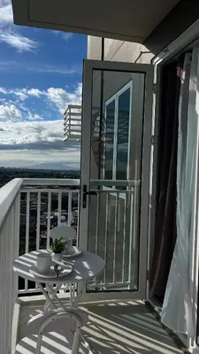 a balcony with a table and a view of the city at Condo Unit in Parañaque by Casa Esplanade in Manila