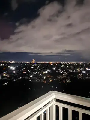 a view of a city at night from a balcony at Condo Unit in Parañaque by Casa Esplanade in Manila