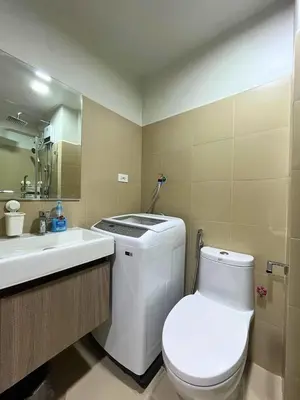 a bathroom with a white toilet and a sink at Shore 3 Residences in Manila