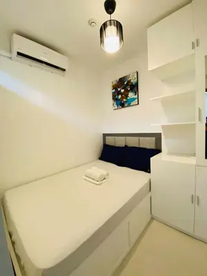 a small bedroom with a white bed in a room at Shore 3 Residences in Manila