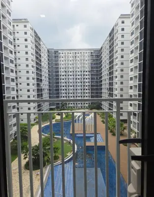 a balcony with a view of a building at Shore 3 Residences in Manila