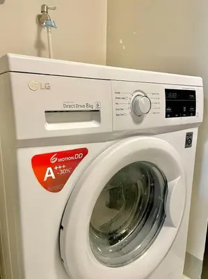 a white washing machine with a sign on it at Uptown Parksuites - Elegant 2 Bedroom Unit with Balcony in BGC in Manila