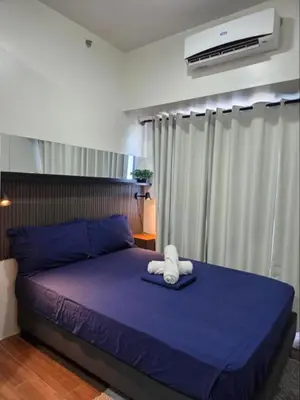a bed with a stuffed animal on top of it at Air Residences in Manila