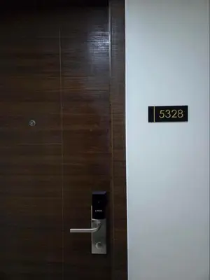 a wooden door with a soap dispenser on it at Air Residences in Manila