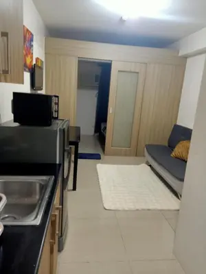 a small kitchen with a couch in a room at Staycation in Shore Residence's in Manila