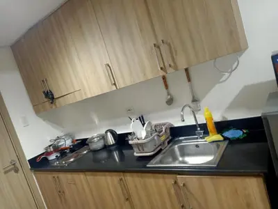 a kitchen with a sink and a counter top at Staycation in Shore Residence's in Manila