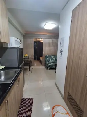 a small kitchen with a sink and a microwave at 3sonstaycation in Manila